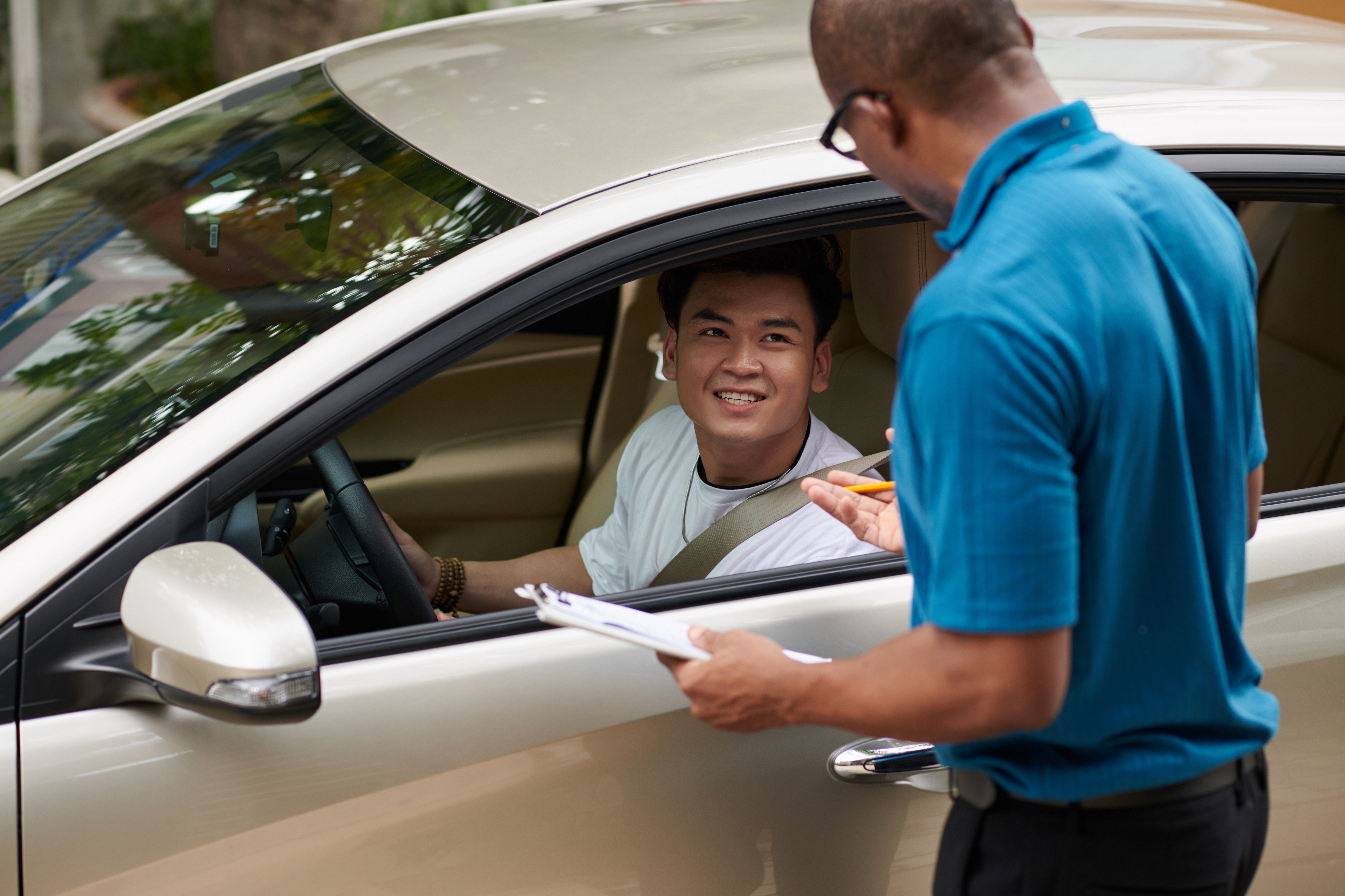 Driving school istructor talking to student before passing exam